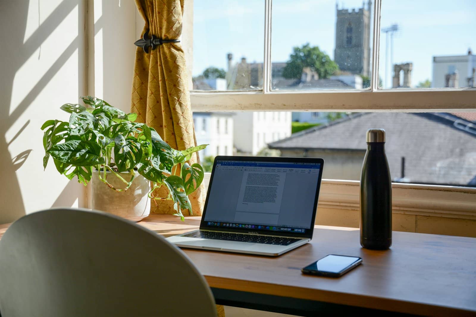A desk by a window in the morning light